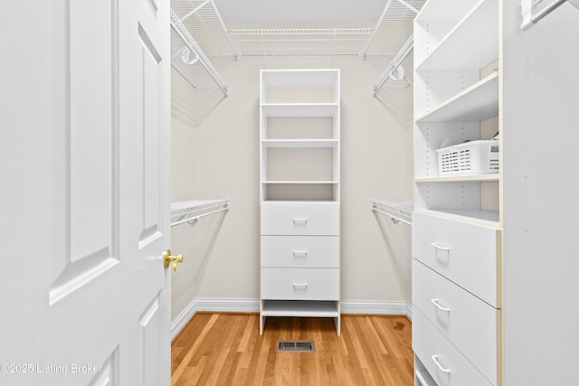 spacious closet featuring hardwood / wood-style floors