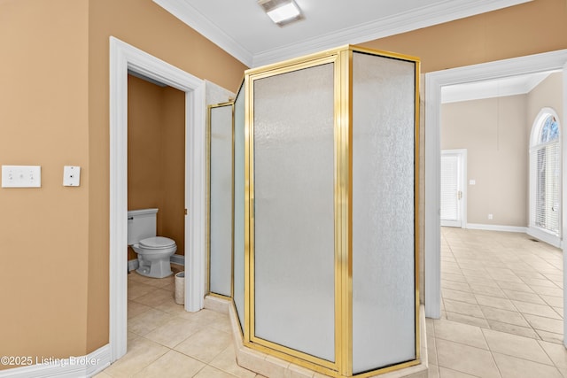 bathroom with toilet, crown molding, tile patterned floors, and a shower with shower door