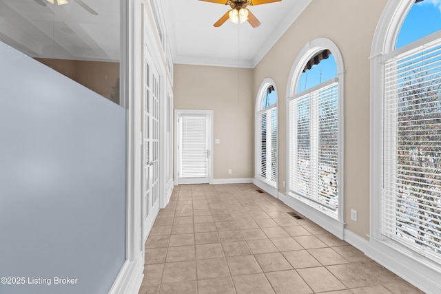 entrance foyer with ceiling fan, light tile patterned floors, and crown molding