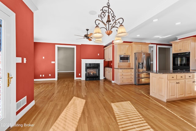 kitchen featuring pendant lighting, light hardwood / wood-style flooring, appliances with stainless steel finishes, light brown cabinets, and ornamental molding