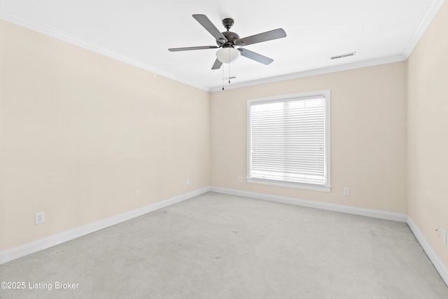 carpeted empty room with ceiling fan and ornamental molding