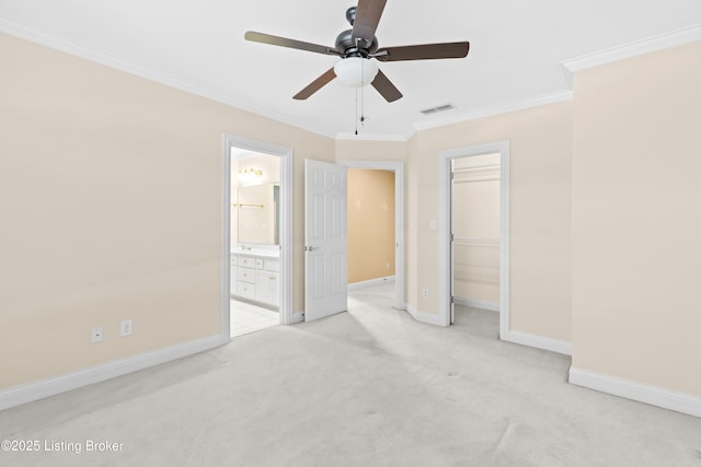 unfurnished bedroom with ceiling fan, connected bathroom, a closet, light colored carpet, and ornamental molding