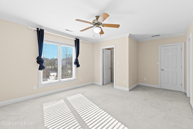 unfurnished bedroom featuring ceiling fan, light carpet, and crown molding