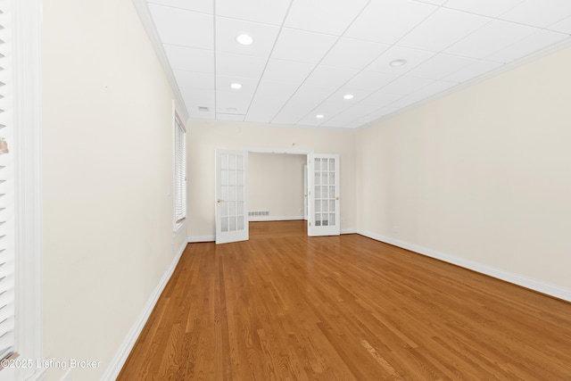 spare room with hardwood / wood-style floors and french doors