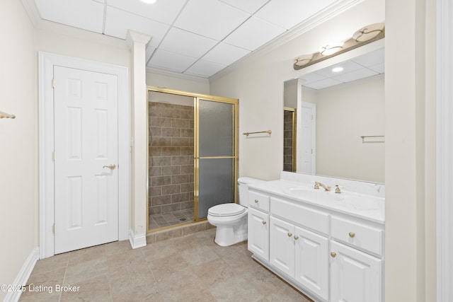 bathroom with toilet, crown molding, a shower with door, and vanity