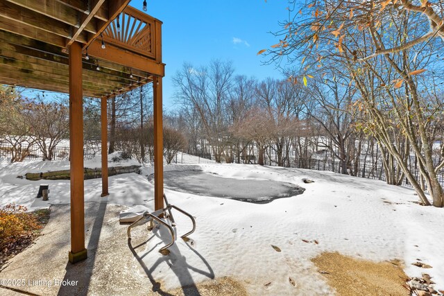 yard covered in snow featuring a deck