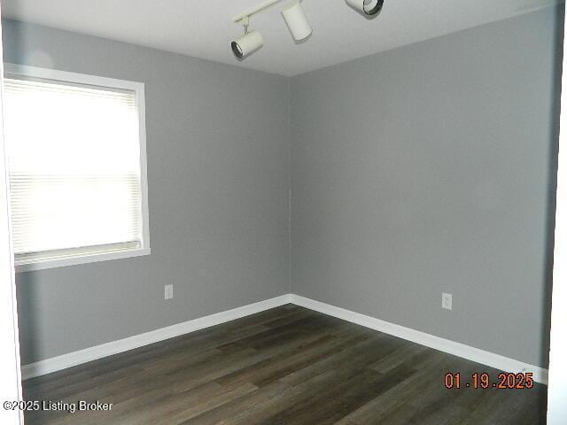 unfurnished room featuring dark hardwood / wood-style flooring