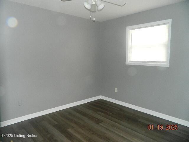 unfurnished room featuring dark wood-type flooring and ceiling fan