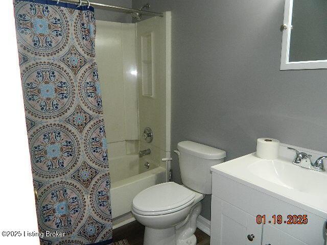 full bathroom featuring vanity, shower / bath combination with curtain, and toilet