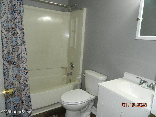 full bathroom with vanity, toilet, and shower / bath combo with shower curtain