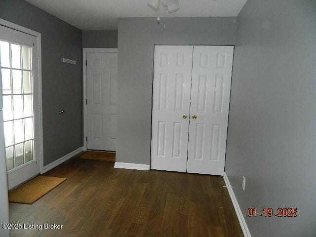 unfurnished bedroom featuring dark hardwood / wood-style floors and a closet