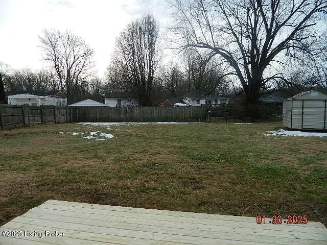 view of yard with a shed and a deck