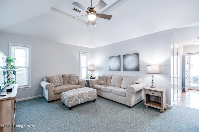 living room with ceiling fan, lofted ceiling, and carpet floors