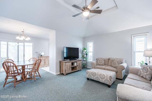 carpeted living room featuring vaulted ceiling and ceiling fan with notable chandelier