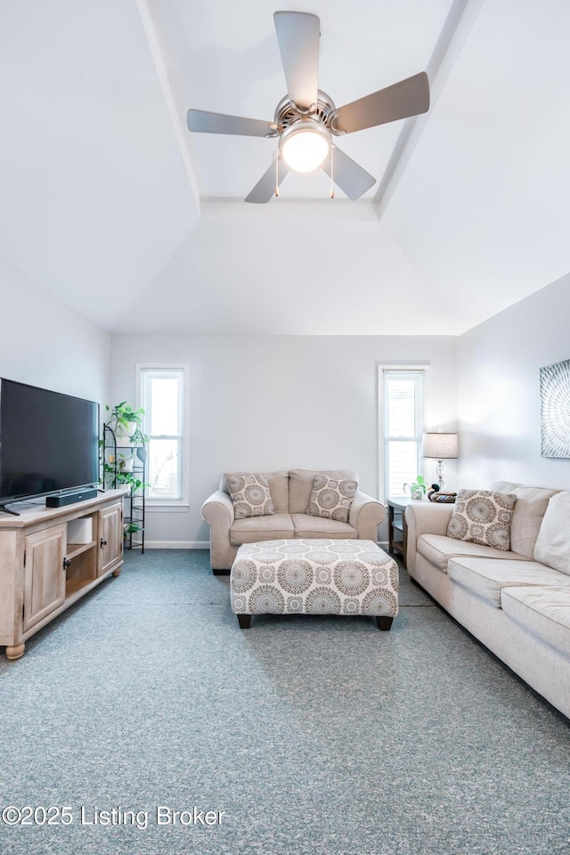 carpeted living room with a tray ceiling, a wealth of natural light, and ceiling fan