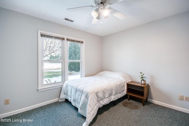 bedroom featuring dark carpet and ceiling fan