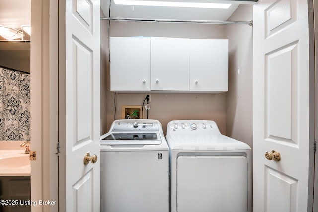 laundry area with cabinets and washing machine and dryer