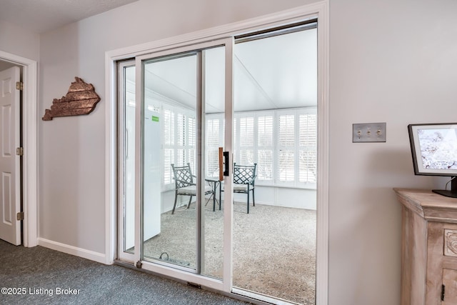 doorway to outside featuring carpet floors