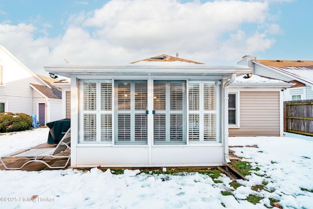 view of snow covered rear of property