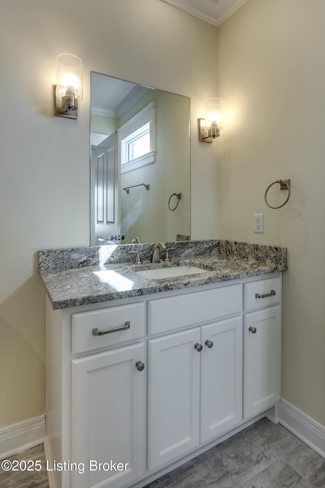 bathroom featuring ornamental molding, marble finish floor, vanity, and baseboards