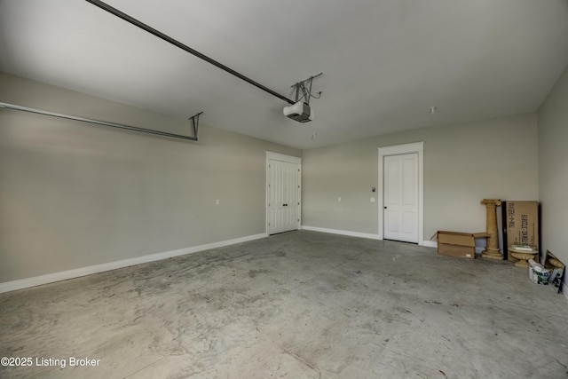 garage with a garage door opener and baseboards