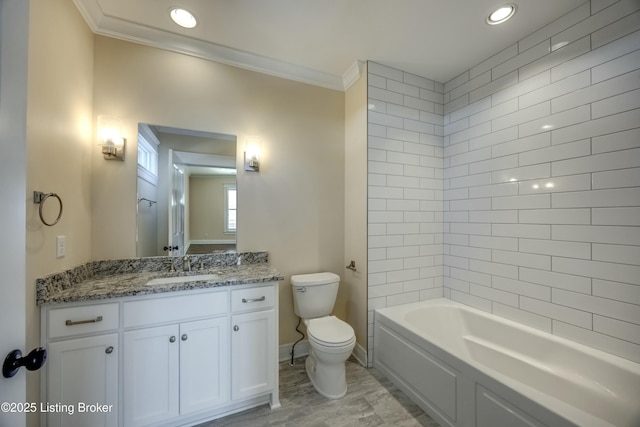 bathroom featuring baseboards, crown molding, vanity, and toilet