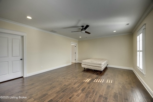 unfurnished room with dark wood-style floors, visible vents, and crown molding