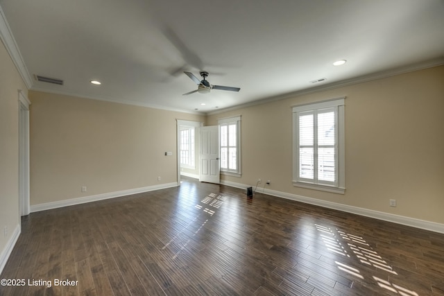 spare room with baseboards, crown molding, visible vents, and dark wood-style flooring