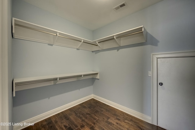 walk in closet with dark wood-style floors and visible vents