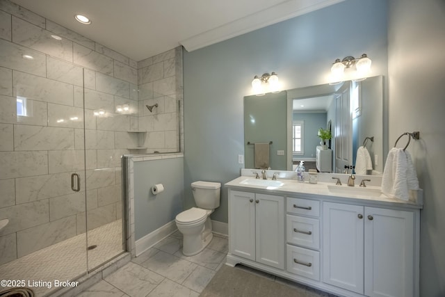 bathroom featuring ornamental molding, a sink, toilet, and a shower stall