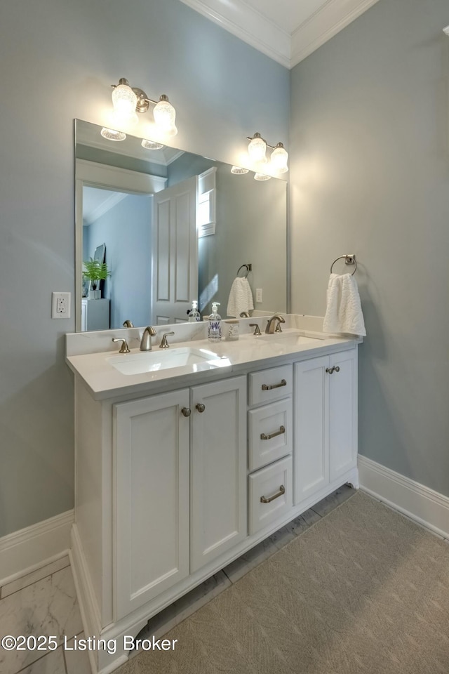 bathroom featuring ornamental molding, a sink, baseboards, and double vanity