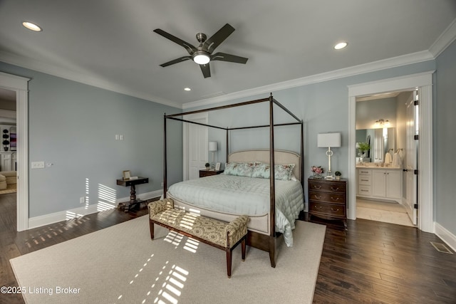 bedroom featuring baseboards, wood finished floors, visible vents, and crown molding