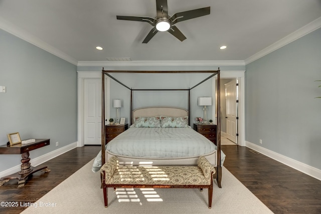 bedroom with baseboards, wood finished floors, and crown molding