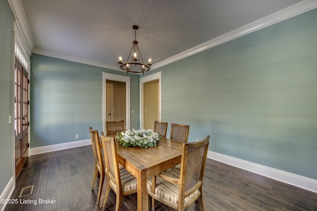 dining space featuring a chandelier, dark wood-type flooring, and baseboards