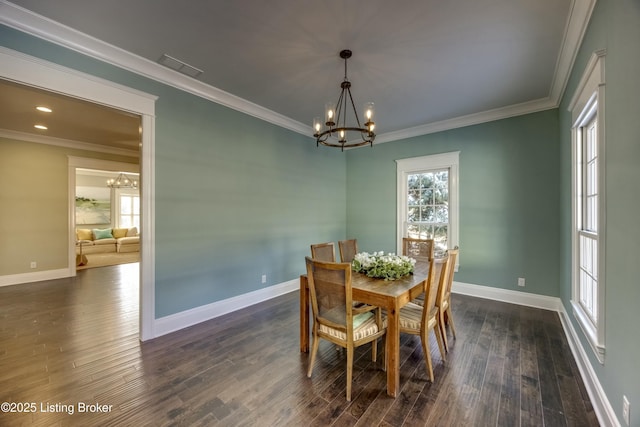 dining space with a chandelier, dark wood-style flooring, baseboards, and crown molding