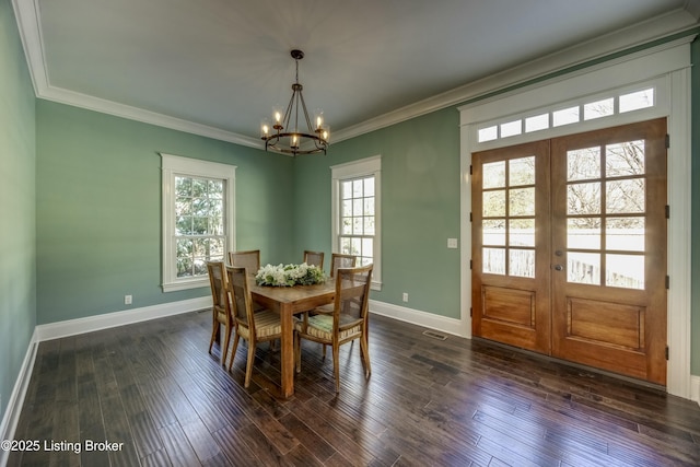 dining room featuring baseboards, dark wood finished floors, crown molding, and french doors