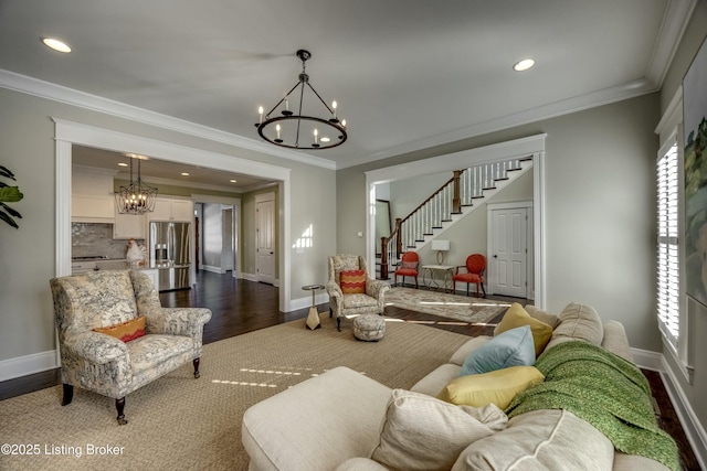 living room with dark wood-style floors, baseboards, stairway, and a notable chandelier