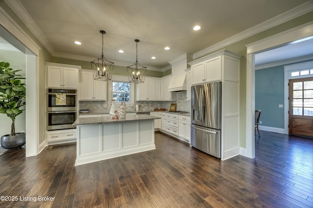 kitchen with white cabinetry, plenty of natural light, appliances with stainless steel finishes, and ornamental molding