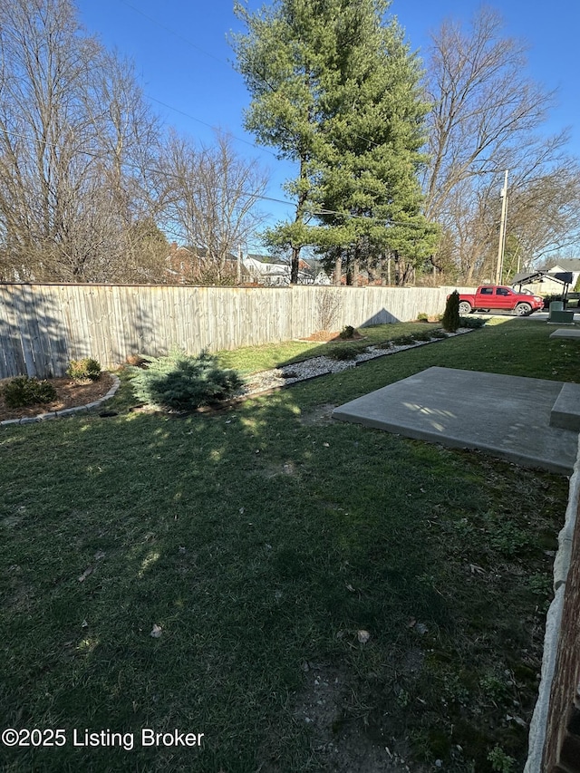 view of yard featuring fence and a patio