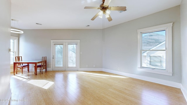 spare room featuring ceiling fan, light hardwood / wood-style flooring, and plenty of natural light