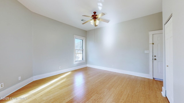 empty room featuring ceiling fan and light hardwood / wood-style flooring