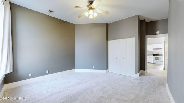 empty room with light carpet and ceiling fan