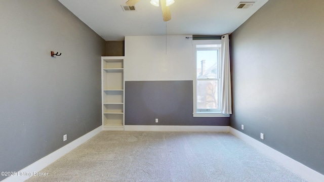 carpeted spare room featuring ceiling fan