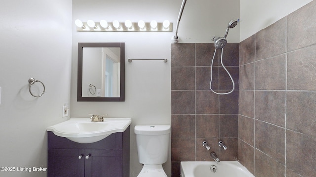 full bathroom featuring toilet, tiled shower / bath combo, and vanity