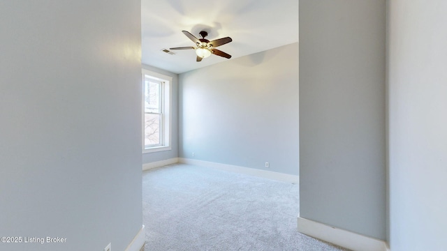 carpeted empty room featuring ceiling fan