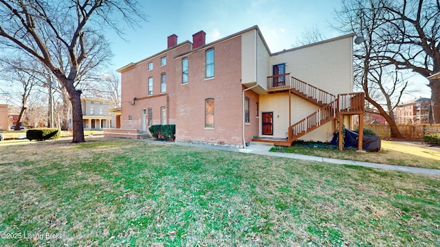 rear view of house with a yard