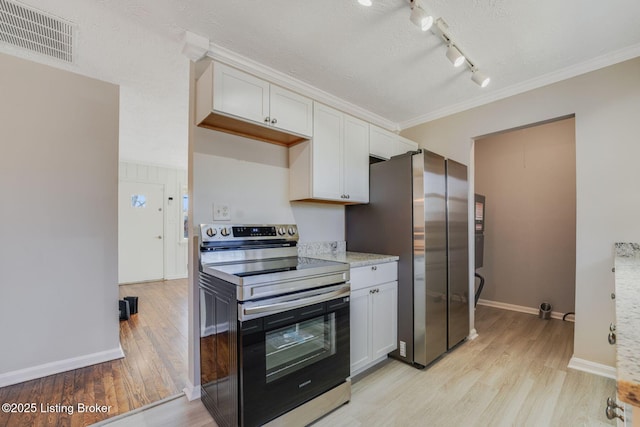 kitchen featuring ornamental molding, appliances with stainless steel finishes, white cabinets, and light hardwood / wood-style floors