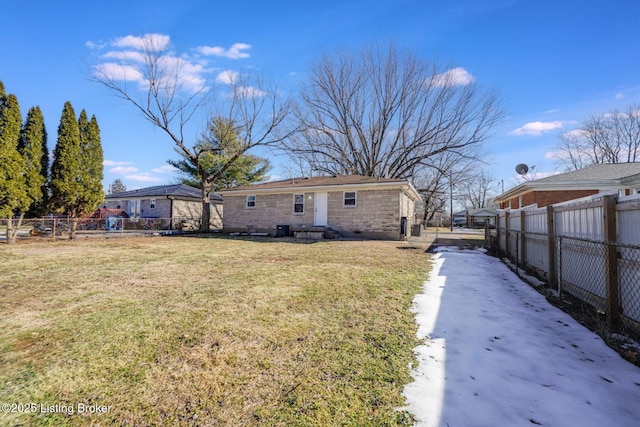 rear view of property featuring a yard