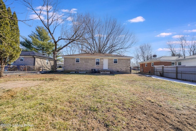 rear view of house featuring a lawn