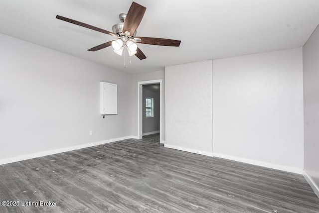 spare room featuring ceiling fan and dark hardwood / wood-style flooring